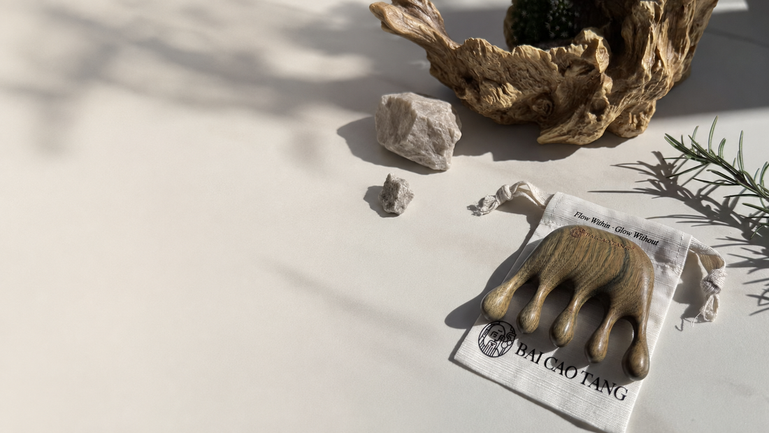 Genuine Bai Cao Tang Green Sandalwood tool on its branded linen pouch in warm natural light.